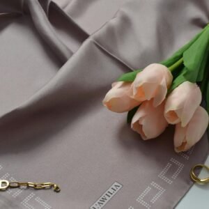 Sophisticated flat lay featuring a silk scarf, pink tulips, and delicate jewelry, perfect for spring aesthetics.