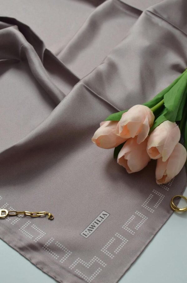 Sophisticated flat lay featuring a silk scarf, pink tulips, and delicate jewelry, perfect for spring aesthetics.